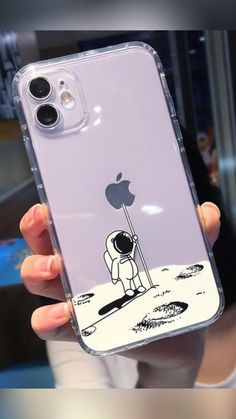 a person holding up an iphone case with a sticker on the back of it