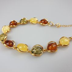 Multi colour Amber bracelet, gold plated Sterling Silver 925 bracelet with hallmarks. Adjustable resizable chain bracelet, gemstone bracelet. Will be just a stunning gif for her. Length : minimum 17,5- max 22.5 cm. Very elegant gemstone bracelet. Weight 11.39 gr. Stone size 1.2-1 cm. very small and cute. This bracelet is small - stones about 1.2 x 1 cm size. This item was made of natural Baltic Amber. All the amber used in my jewelry is collected in my home country Lithuania. I sell only genuine Small Necklace, Amber Bracelet, Bracelet Gemstone, Amber Necklace, Mens Leather Bracelet, Pretty Bracelets, Amber Jewelry, Nice Leather, Bracelet Gold