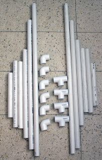 several white pipes are lined up on the floor