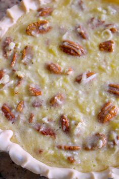 a pie crust with pecans and cheese on top