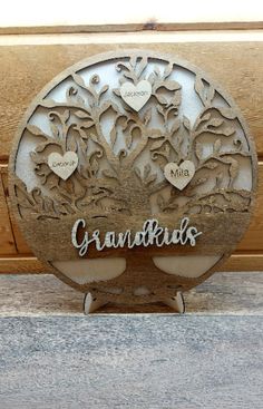 a wooden sign that says grandkids with hearts and flowers on the front side