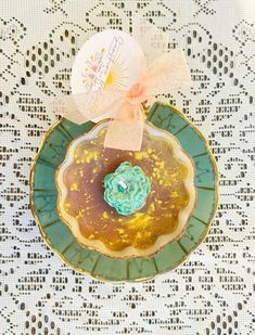 a plate with a donut on it sitting on a doily