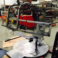 an assembly line in a factory with equipment on the floor and behind it is a machine