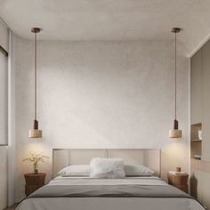 a bed with two lamps hanging from it's sides in a room that has white walls and wooden floors