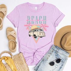 Ditch the dull and show off your wild side with our "Beach Babe Van" tee! This retro-inspired piece is just the thing to show off your cool, laid-back style with its throwback van and groovy palm tree graphics. Let's hit the beach! Size Guide: we recommend your true size for a loose fit or size down for a fitted fit. Tees are Unisex. Heather blend shirts are 52/48 Cotton/ Poly Blend and Shirts are Unisex. CREW NECK SIZING: Small - Length, 28" Width, 18" (4/6) Medium - Length, 29", Width, 20" (8/ Summer Cotton T-shirt With Palm Tree Print, Tropical Graphic Print T-shirt For Beach, Cotton T-shirt For Summer Vacation, Bohemian Crew Neck T-shirt For Summer, Bohemian Short Sleeve Beach T-shirt, Casual Beach T-shirt For Warm Weather, Trendy Palm Tree Print Top For Vacation, Screen Print T-shirt For Beach Vacation, Summer Vacation Tops With Palm Tree Print