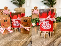 three wooden boxes decorated with christmas decorations on top of a table in front of trees