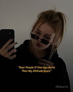 a woman wearing sunglasses and looking at her cell phone with the caption dear people if your egg barks then my attitude roars