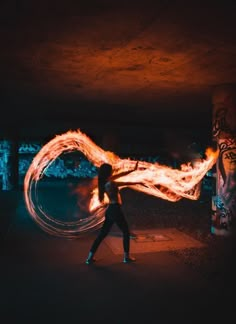 a woman is spinning fire in the dark