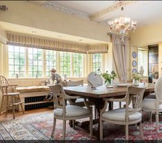 a dining room table with chairs and a chandelier