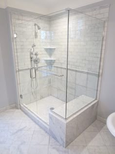 a walk in shower sitting inside of a bathroom