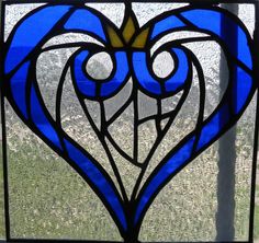 a stained glass window with a heart shaped design