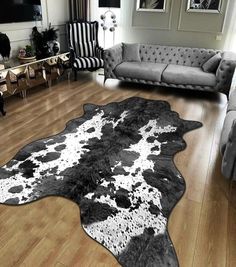 a living room filled with furniture and a cow skin rug