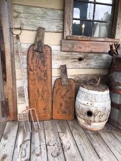 an old wooden porch with two buckets and some other items