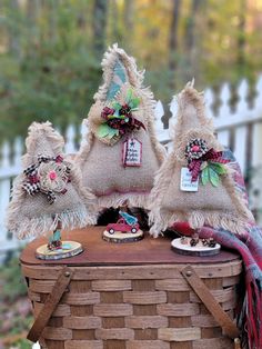 three burlap hats sitting on top of a basket