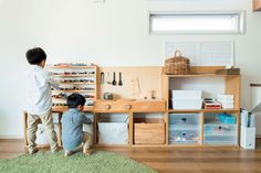 two children playing with toys in a playroom