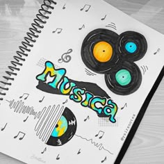 a spiral notebook with music themed stickers on it