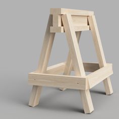 an unfinished wooden chair on a gray background