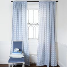 a blue chair sitting in front of a window