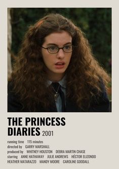 a woman with glasses and long hair in front of a poster for the princess diaries