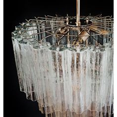 a chandelier hanging from the ceiling with glass rods on it's sides