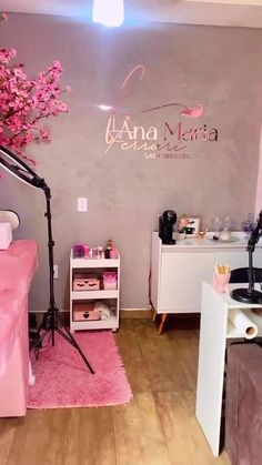 a salon with pink furniture and flowers on the wall