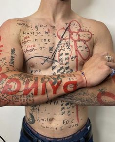 a man with tattoos on his chest and arms