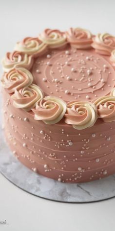 a close up of a cake on a plate with icing and sprinkles