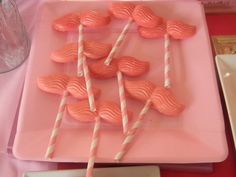 pink candy lollipops are arranged on a pink plate