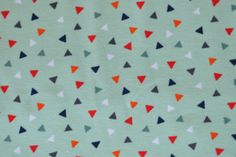 a green background with red, white and blue triangles