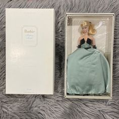 the barbie doll is in its original box