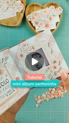 someone is making an album with flowers and laces on it in the shape of hearts