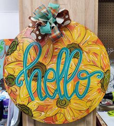 a wooden sign with the word hello painted on it