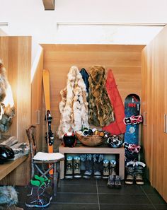 there are many coats and skis in the closet