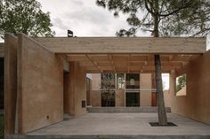 an empty building with a tree in the middle