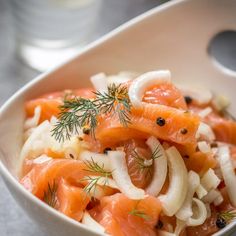 a white bowl filled with carrots and onions