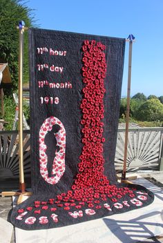 a black and red banner with flowers on it