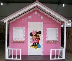 a pink house with minnie mouse painted on it