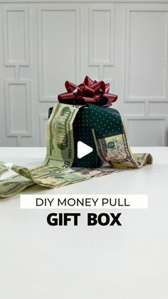 a gift box with money wrapped around it and the words diy money pull on top