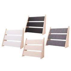 three wooden shelves with different colors and designs on them, one is white, the other is black