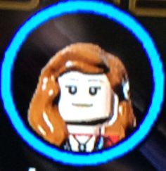 a close up of the face of a lego character on a television screen with blue ring around it