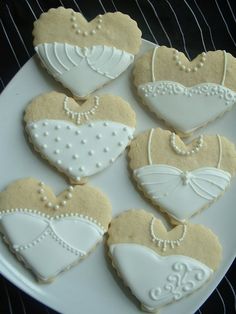 some decorated cookies are on a white plate