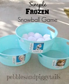 three buckets filled with frozen snowballs sitting on the ground