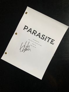 a piece of paper with the word paradise written on it and some gold studs