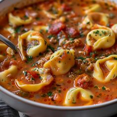 a white bowl filled with pasta and meat soup