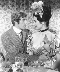 an old photo of a man and woman at a dinner table