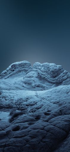 some very pretty rocks in the middle of a dark blue sky, with one rock sticking out from it's surface