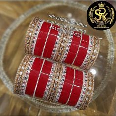 two red and gold bangles on a clear glass plate with the words srk bridal