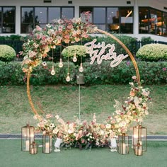 a wedding arch decorated with flowers and candles for the entrance to the reception room at an outdoor venue