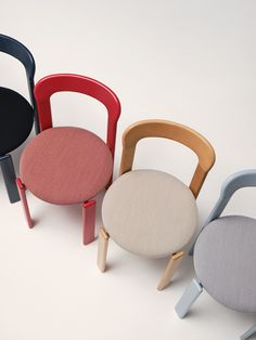 four different colored chairs sitting next to each other