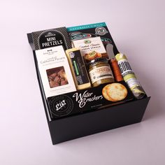 a black box filled with food and condiments on top of a white table